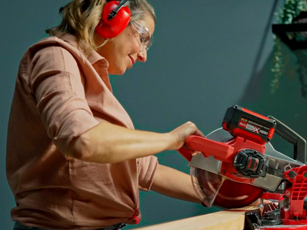 A woman works with a circular saw