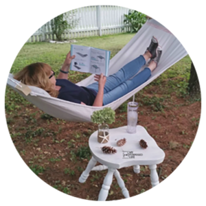  A woman is reading in a hammock